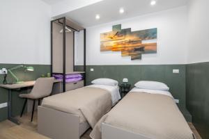 a hospital room with two beds and a desk at La Rosa dei Venti in San Donato Milanese