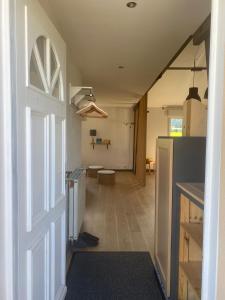 a hallway of a kitchen with a door open at Les Épinettes Appartement 6 in Prémanon