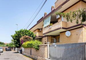 a building with a fence in front of it at Fiumicino King's Guest House - Comfort Rooms in Fiumicino
