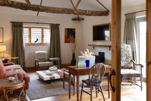 a living room with a table and chairs at Husk in Thorington