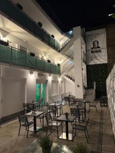 a patio with tables and chairs at night at Boutique-Hotel Goethe in Munich