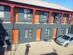 a car parked in front of a building at FGM Guesthouse 2 in Alberton