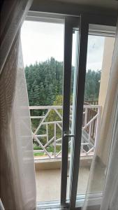 an open window with a view of a balcony at Devlok Inn in Lohaghāt