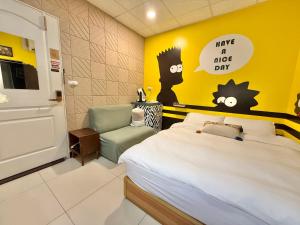 a bedroom with a bed and a yellow wall at 斑比Bambi in Tainan