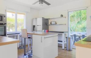 a kitchen with white appliances and a table with chairs at Spacieuse Maison De Ville in Étaples