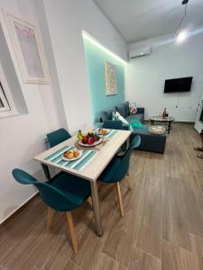 a living room with a table and chairs and a couch at Charavgi House in Archangelos