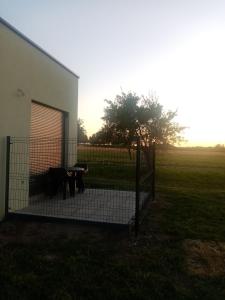 a fence in front of a building with a tree at Le doux refuge 67 in Schwabwiller