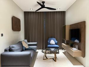 a living room with a couch and a ceiling fan at Sky Suites klcc in Kuala Lumpur