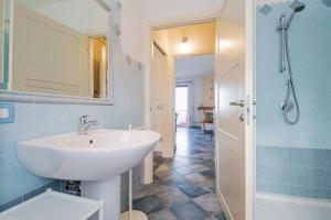 a bathroom with a sink and a shower at Biriola EcoResort Cala Gonone in Cala Gonone