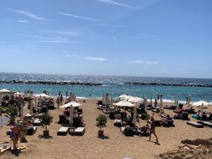 a beach with chairs and umbrellas and the ocean at King's Palace nice apartments 2bd, 2bath sea view in Paphos City