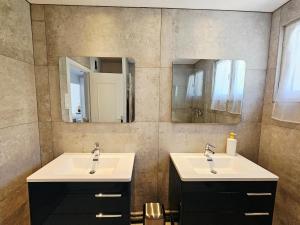 a bathroom with two sinks and two mirrors at Appartement trois chambres avec jardin in Montboucher-sur-Jabron +13 photos