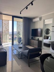 a living room with a couch and a table at Kabazela at Ellipse in Midrand