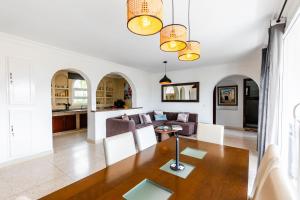 a living room with a table and a couch at Seabreeze 2BR Haven Ocean Walk and Sunsets in Tamellalt +39 photos