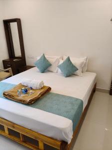Postel nebo postele na pokoji v ubytování Saai Residency Tiruvannamalai