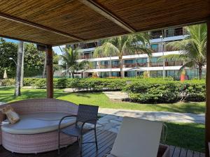 a patio with a table and chairs and a building at Baobá Residence Porto de Galinhas Beira Mar na Vila in Porto De Galinhas