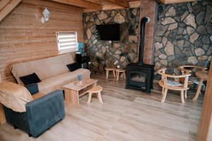 a living room with a couch and a wood stove at Vidikovac Dubljevici in Plužine