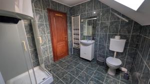 a bathroom with a toilet and a sink at Casa Bianca in Băile Herculane +18 photos
