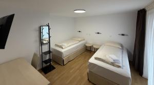a small room with two beds and a mirror at Boutique-Hotel Goethe in Munich