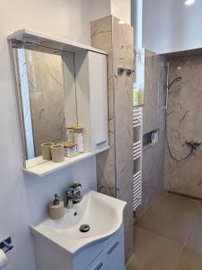 a white bathroom with a sink and a shower at La Perla Centre in Zagreb +20 photos
