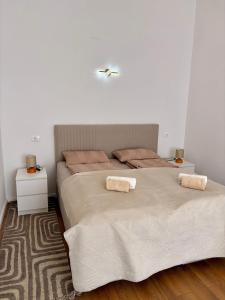 a bedroom with a large bed with two pillows at La Perla Centre in Zagreb