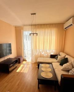 a living room with a couch and a table at Apartment Skу in Kavarna