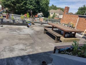 a group of benches sitting in a parking lot at Comfy Studio - Sleeps 2 Near Warwick University in Coventry +6 photos