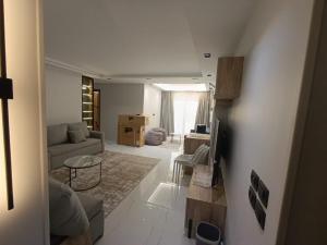 a living room with a couch and a table at Hotel Apt, in a Compound, Cairo central Location, Maadi Mokattam New Cairo in Cairo +34 photos