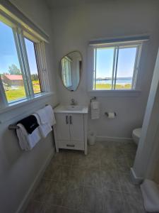 a bathroom with a sink and a mirror at Hunts Point 1-BR Coastal Retreat - Cottage # 7 in Summerville Centre