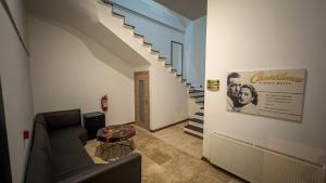 a living room with a couch and a staircase at Casablanca Garden Hotel in Nevsehir