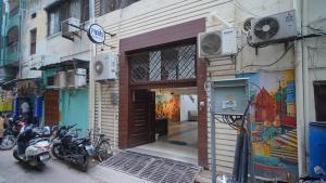 a building with motorcycles parked in front of a door at Raahi - 3 Bedroom Flat Near Kashi Vishwanath in Varanasi