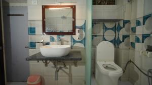 a bathroom with a sink and a toilet at Raahi - 3 Bedroom Flat Near Kashi Vishwanath in Varanasi +55 photos
