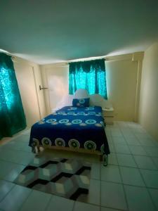 a bedroom with a blue bed with blue curtains at Valley View in Saint George