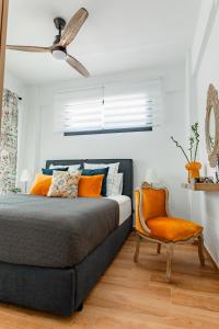 a bedroom with a bed and a ceiling fan at Mare Blue The Vintage Suite in Skala Rachoniou +81 photos