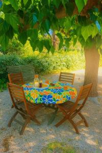 a table and two chairs sitting under a tree at Les Mûriers in La Ciotat