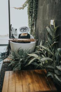 a bathroom with a bath tub sitting next to plants at Bajo Estrellas Hotel Contemporáneo in Valle de Guadalupe +72 photos
