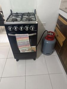 a stove in a kitchen with a pot next to it at June’s comfort paradise in Runaway Bay