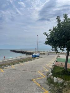 a parking lot next to a beach with a boat at Atlantic in Pomorie