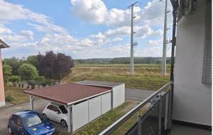 a small car parked next to a building with a roof at Ferienwohnung mit Kanalblick in Hirschaid