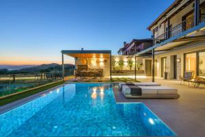 a swimming pool in the backyard of a house at Thea Suites in Ouranoupoli