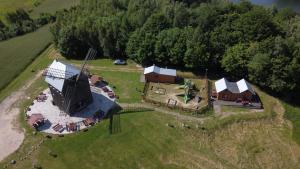 an aerial view of a farm with a house and a barn at Wiatrak in Ręboszewo