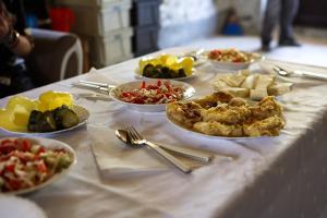 a table with many plates of food on it at Guest House Tofaj in Deçan