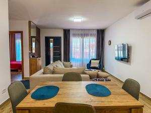 a living room with a table and a couch at TaNa's Villa in Donji Štoj