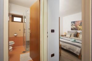 a bathroom with a bed and a toilet in a room at Apartments Casa Antico in Premantura +42 photos