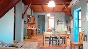 a kitchen and dining room with a table and chairs at Villa Mugs in Tirana