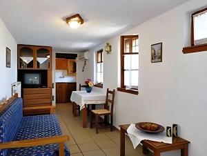 a living room with a kitchen and a dining room at Guesthouse Apanemia in Afissos
