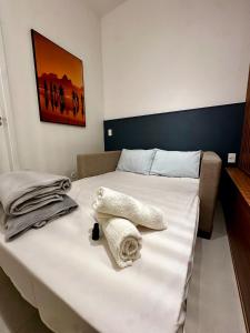 a bedroom with a bed with towels on it at Studio Pé na Areia, Copacabana in Rio de Janeiro