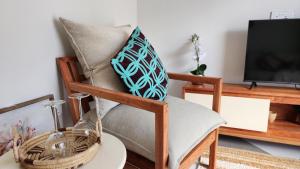 a chair with a pillow on it with a table at Peter's Nest in Livingstone