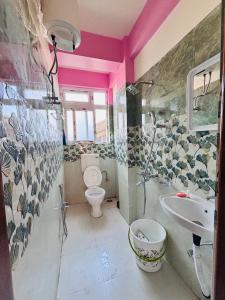 a bathroom with a toilet and a sink at Stargaze Backpackers Shillong in Shillong +33 photos