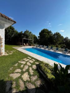 a swimming pool with chairs next to afficientfficientfficientfficientfficientfficient at Villa Allyson Boutique Guesthouse in Lloret de Mar