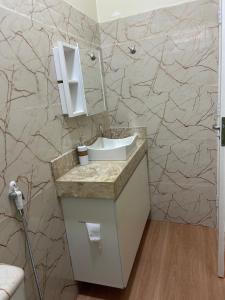 a bathroom with a sink and a mirror at Casinha da Ana in Bacabal